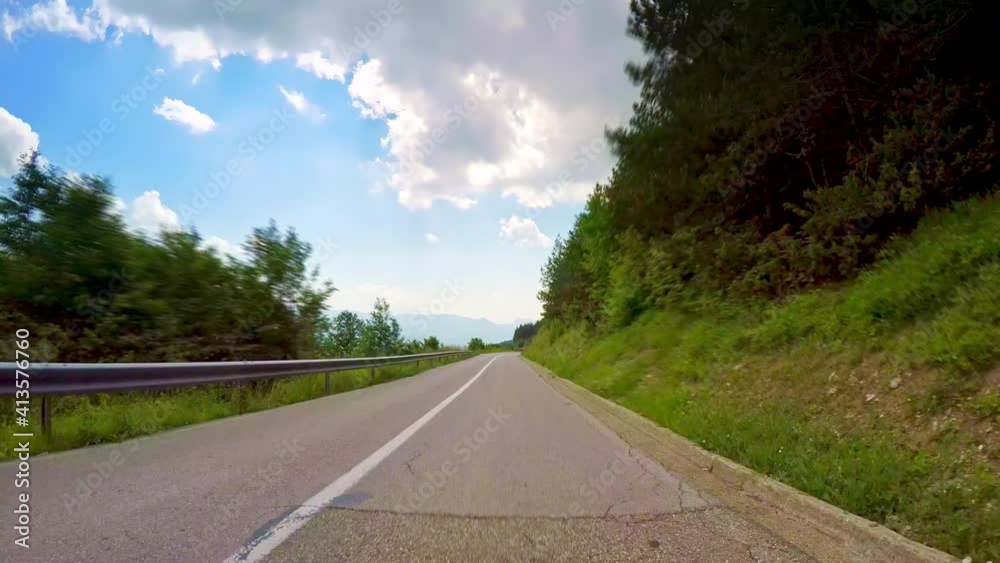 Beautiful nature POV drive, lush forest green trees, mountain peaks, blue sky clouds skyline, curvy asphalt road car travel gopro point of view Beautiful nature POV drive, lush forest green trees, mountain peaks, blue sky clouds skyline, curvy asphalt road car travel gopro point of view