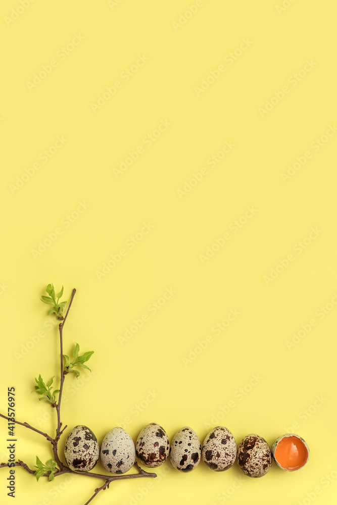 Decorative composition - quail eggs and a spring branch on a delicate yellow background. The concept of celebrating Easter, greeting card, dietary nutrition. Top view, flatly.