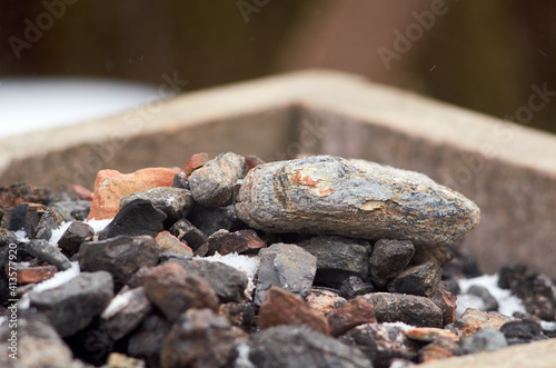 Burnt lumps of coal in a box