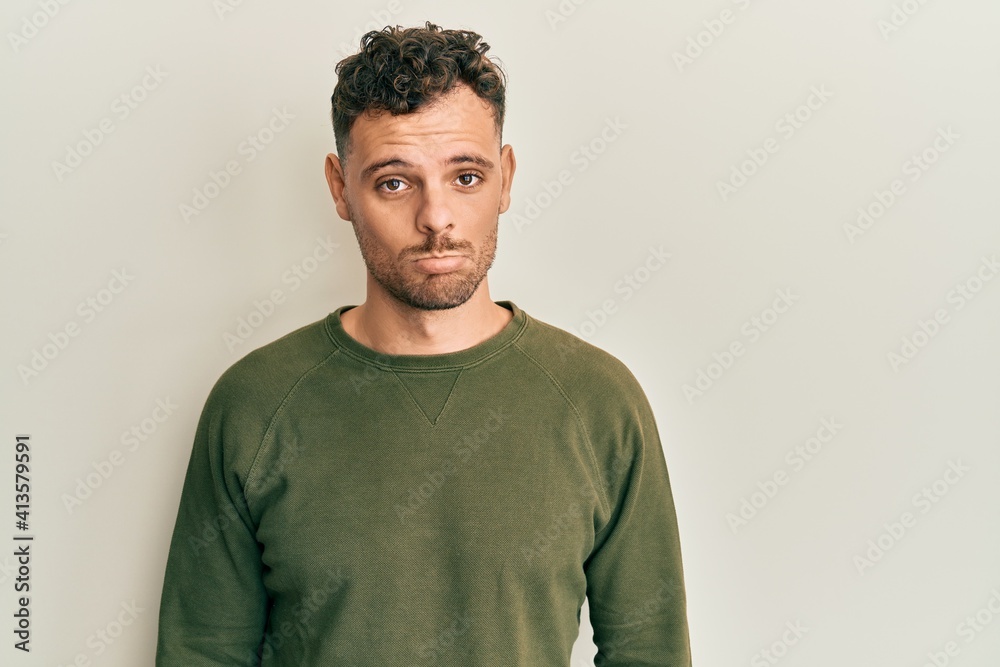 Young hispanic man wearing casual clothes depressed and worry for distress, crying angry and afraid. sad expression. Young hispanic man wearing casual clothes depressed and worry for distress, crying angry and afraid. sad expression.