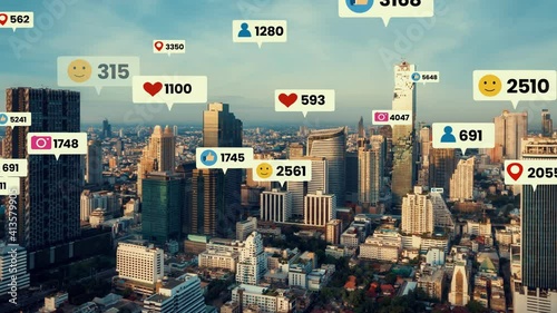Social media icons fly over city downtown showing people engagement connection through social network application platform . Concept for online community and social media marketing strategy . photo