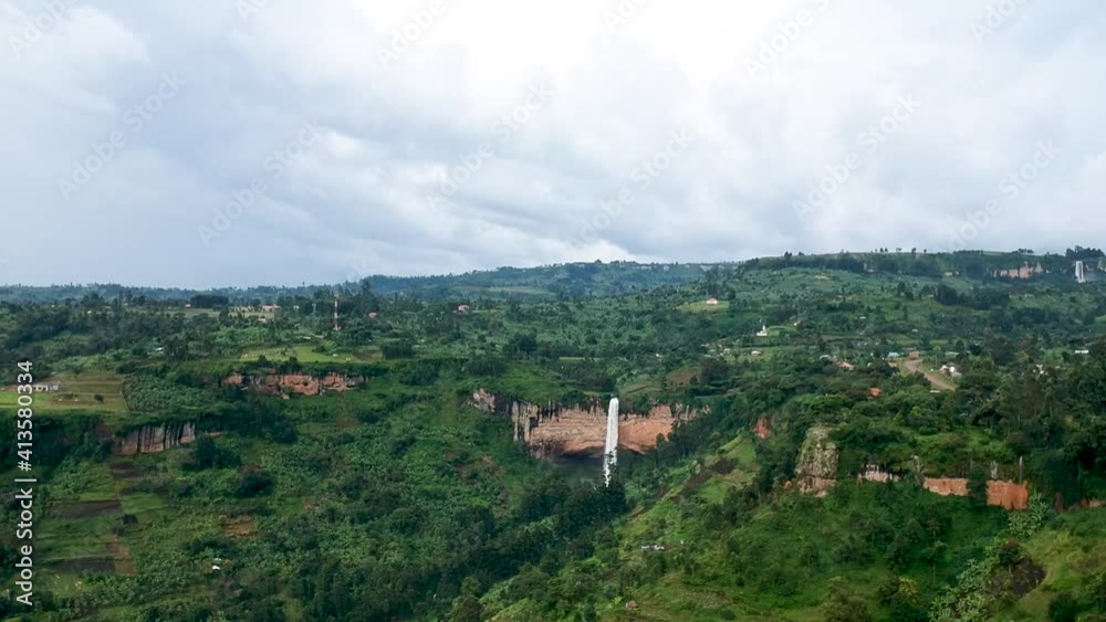 Big waterfall in the distance on green hills in Northern Uganda Big waterfall in the distance on green hills in Northern Uganda