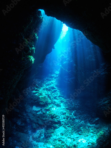 Underwater world. Rays of light in an underwater cave. Red sea.