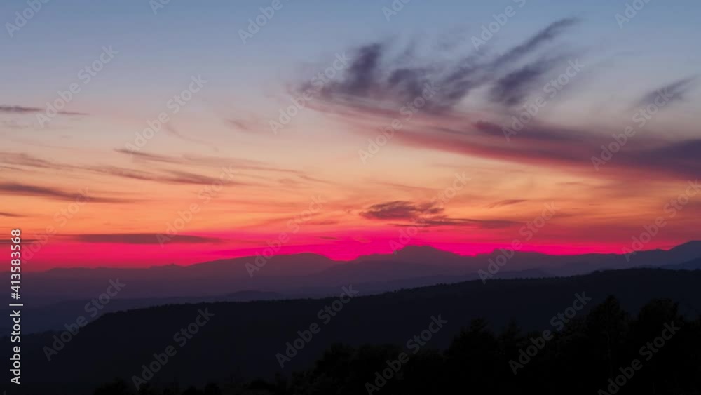 Cloudy sunset tinted red over the mountains. Cloudy sunset tinted red over the mountains.