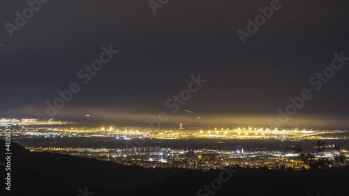 Night Timelapse with Moving Lights from Commercial Planes at Josep Tarradellas Barcelona-El Prat Airport.  photo