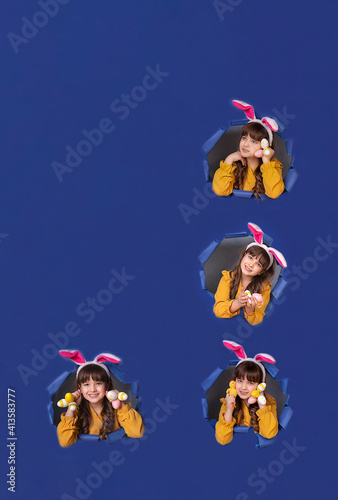 Spring season concept. Closeup photo portrait of positive glad nice pretty beautiful fashionable small lady demonstrating collection of colorful bright easter eggs in palms blue background