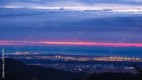 Cloudy Sunrise Timelapse with Moving Lights from Commercial Planes at Josep Tarradellas Barcelona-El Prat Airport.  photo