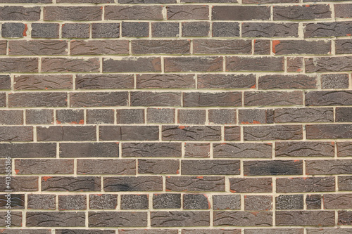 Brown brick background of beautiful unusual building brick with whole bricks and brick parts