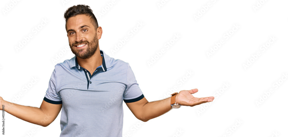 Handsome man with beard wearing casual clothes smiling showing both hands open palms, presenting and advertising comparison and balance Handsome man with beard wearing casual clothes smiling showing both hands open palms, presenting and advertising comparison and balance