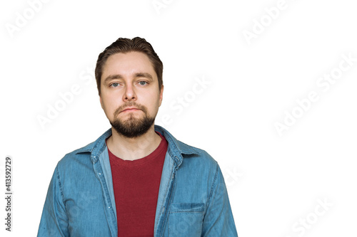 a young attractive blond man in a T-shirt and denim shirt on a white isolated background. portrait of a man