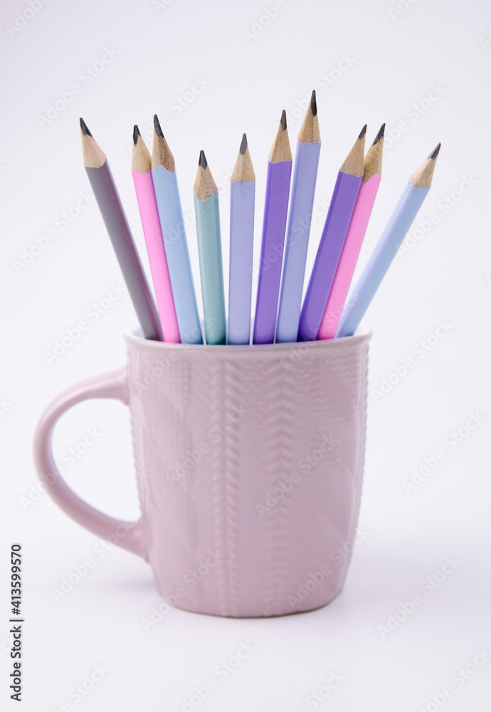 colorful pencils in a pink circle on a white background