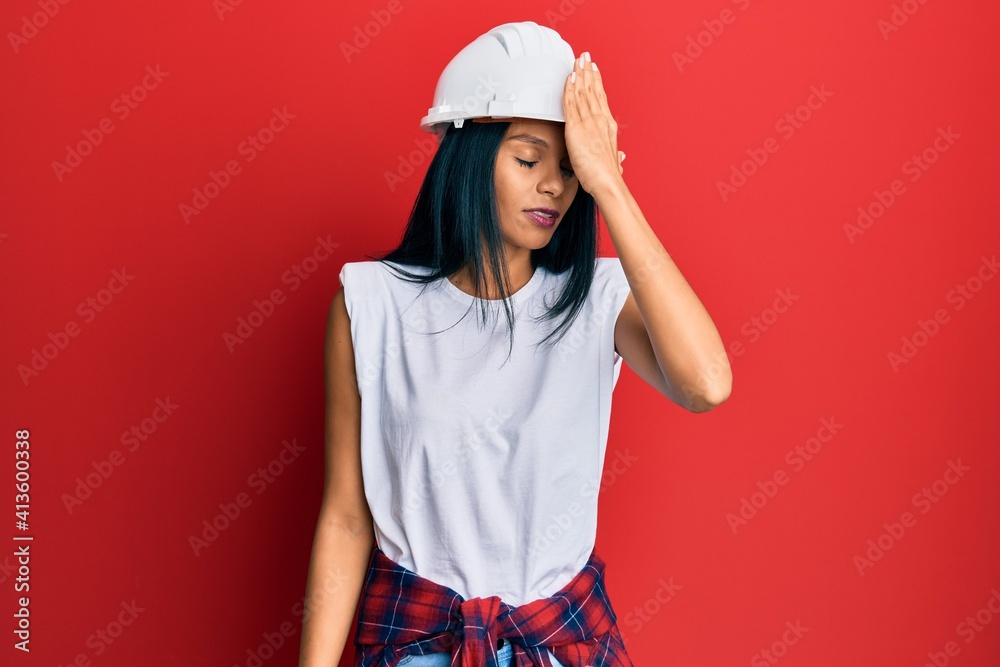 Young african american woman wearing architect hardhat surprised with hand on head for mistake, remember error. forgot, bad memory concept. Young african american woman wearing architect hardhat surprised with hand on head for mistake, remember error. forgot, bad memory concept.
