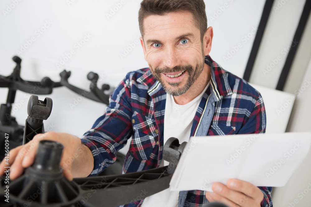 happy man fixing a chair happy man fixing a chair