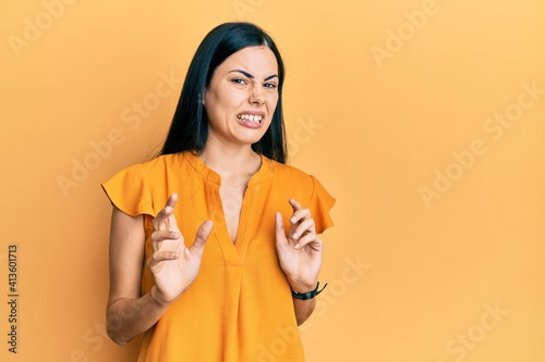 Canvas Print Beautiful young woman wearing casual clothes disgusted expression, displeased and fearful doing disgust face because aversion reaction