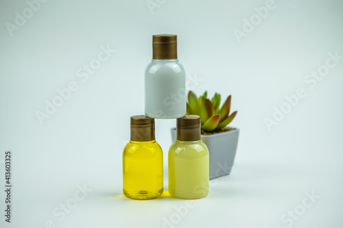 A nice picture of some lotions in hotel bottles on a table