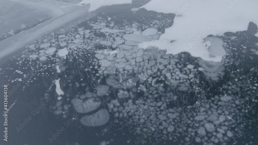 Methane bubbles frozen in Arctic lake surface ice - Climate change ...