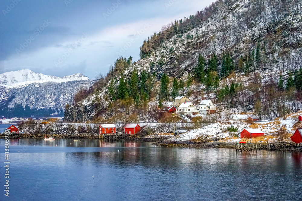 Norway, the village Ornes in December during the day. Typical wooden houses on the coastline