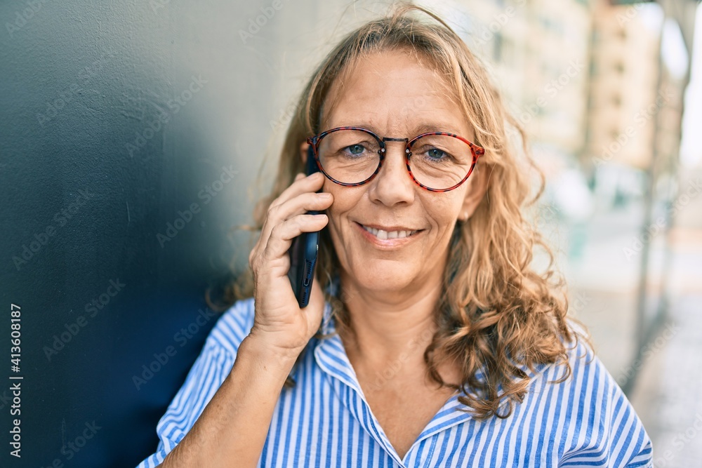 Middle age caucasian woman smiling happy talking on the smartphone at the city. Middle age caucasian woman smiling happy talking on the smartphone at the city.