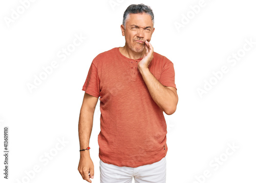 Handsome middle age man wearing casual clothes touching mouth with hand with painful expression because of toothache or dental illness on teeth. dentist