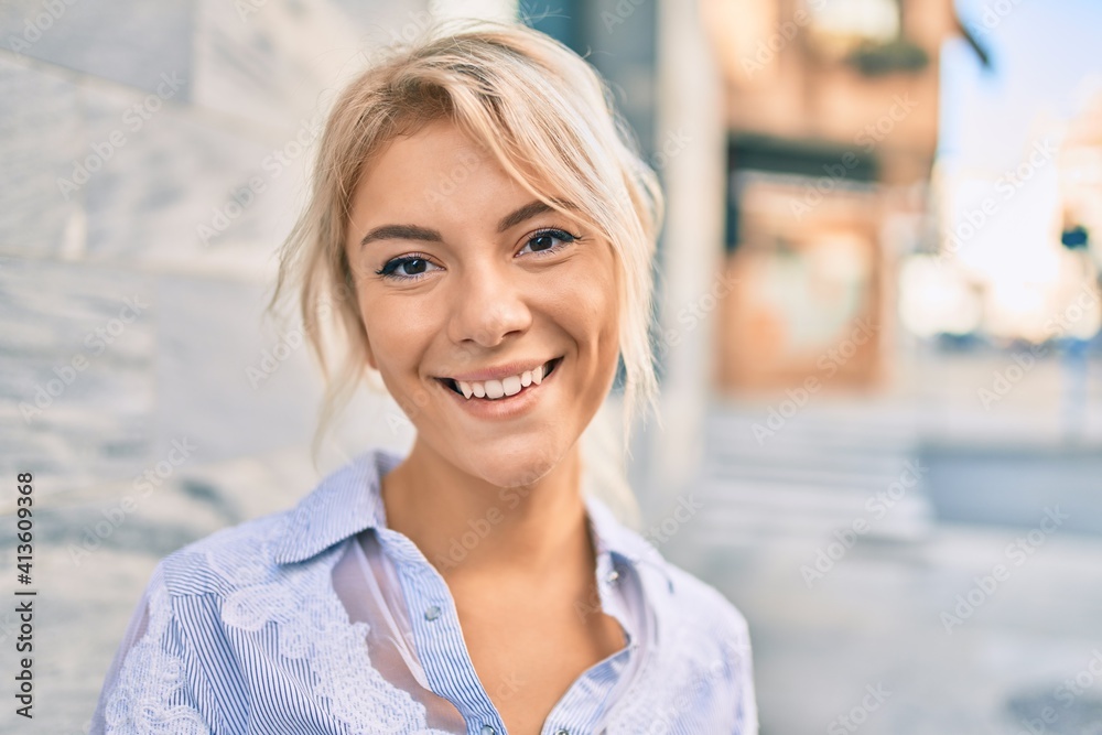 Young blonde woman smiling happy walking at the city. Young blonde woman smiling happy walking at the city.