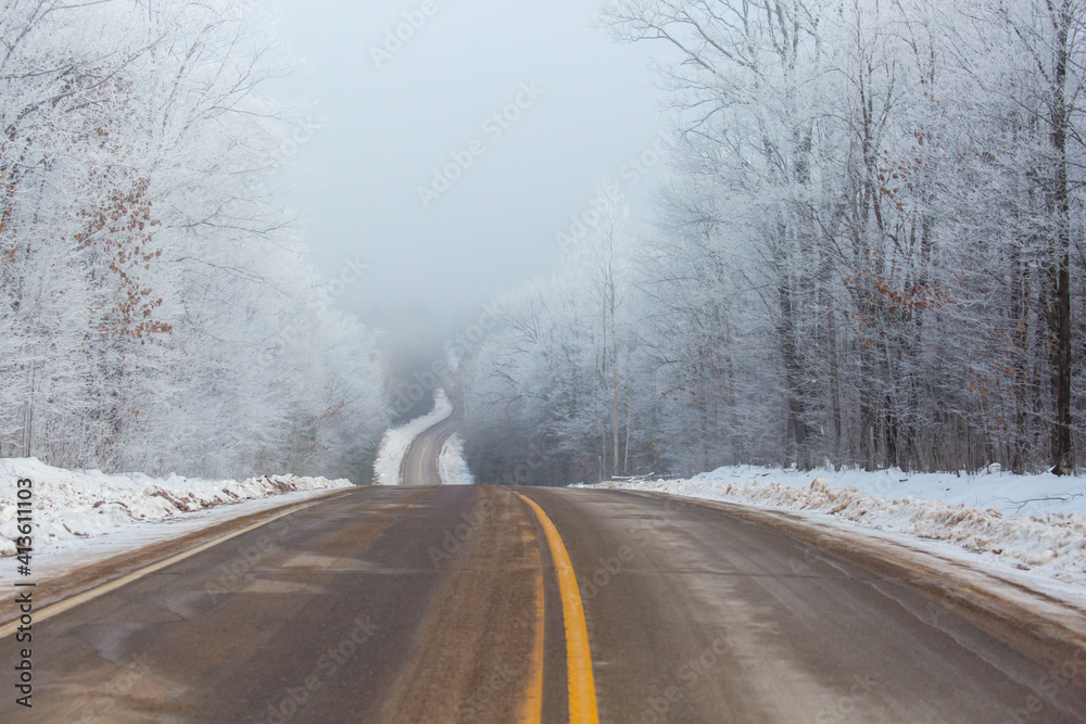 Steep hill on county highway K in Merrill, Wisconsin on a foggy winter day Steep hill on county highway K in Merrill, Wisconsin on a foggy winter day