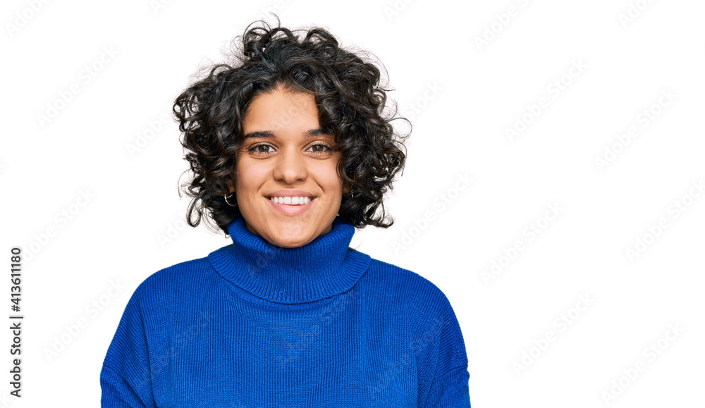 Young hispanic woman with curly hair wearing turtleneck sweater with a happy and cool smile on face. lucky person. Young hispanic woman with curly hair wearing turtleneck sweater with a happy and cool smile on face. lucky person.