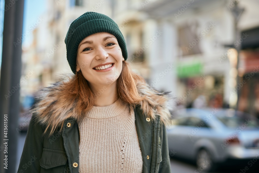 Fototapeta premium Young caucasian girl smiling happy standing at the city.