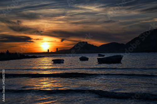 beautiful sunset on the beach with boats and very colorful on the beach of Alicante  Spain