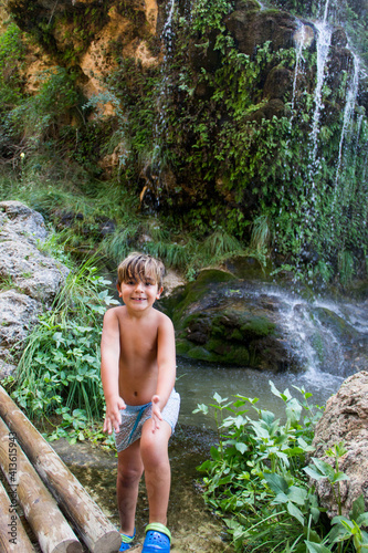 boy in swimsuit, next to river, in batan de bogarra, albacete photo