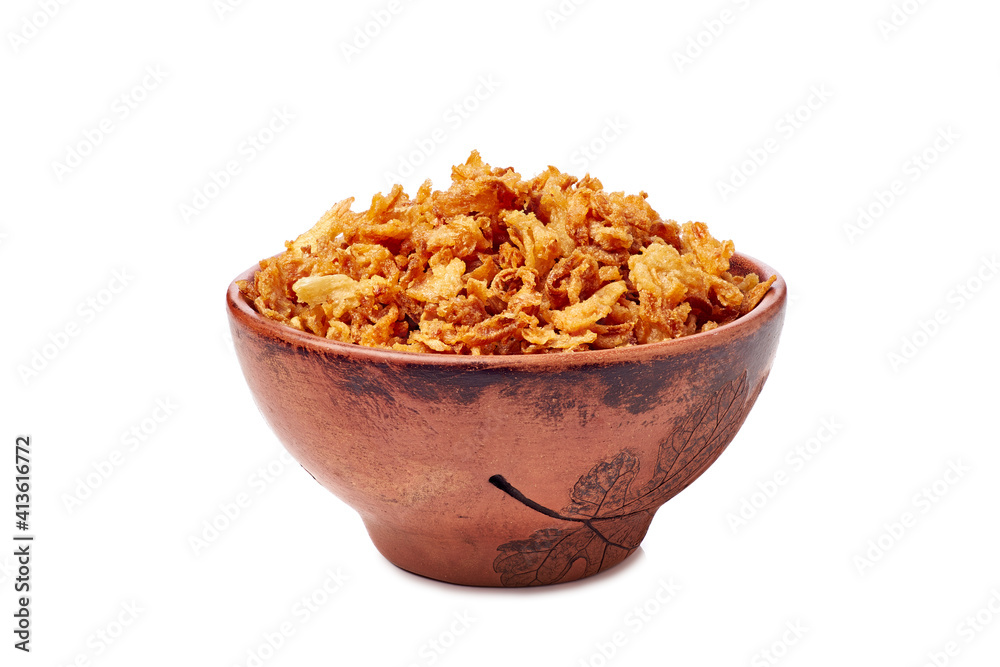 Bowl of crispy fried onion flakes on white Bowl of crispy fried onion flakes on white