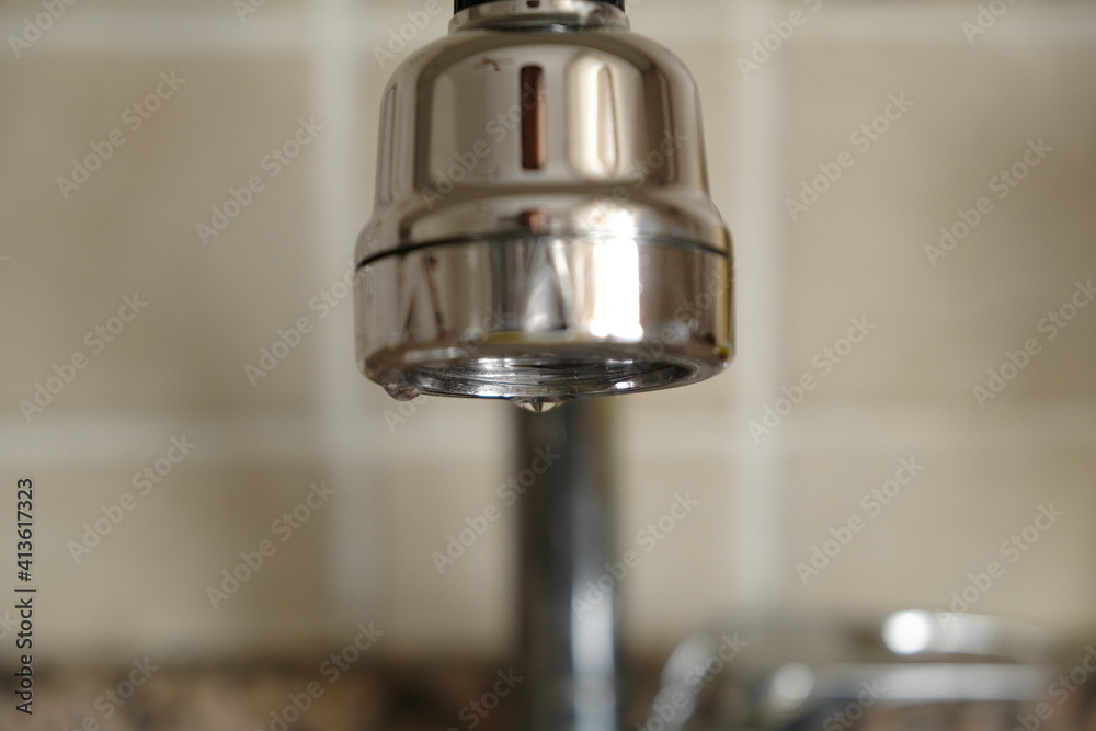 Saving on water.Water saving fountain apparatus in the kitchen.Personal measures for the climate crisis.Global warming concept. Saving on water.Water saving fountain apparatus in the kitchen.Personal measures for the climate crisis.Global warming concept.