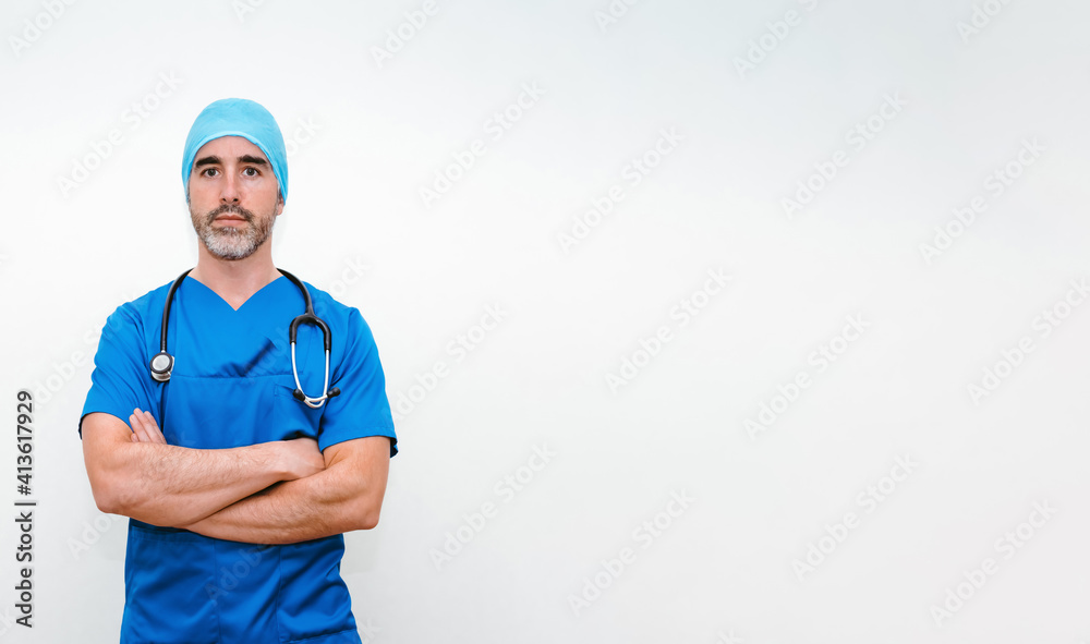 Doctor in surgical outfit standing with his arms crossed Doctor in surgical outfit standing with his arms crossed