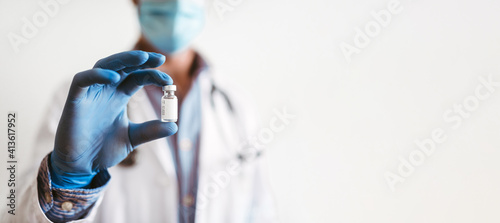 Valokuva Selective focus in a glass jar in the hands of a doctor wearing gloves