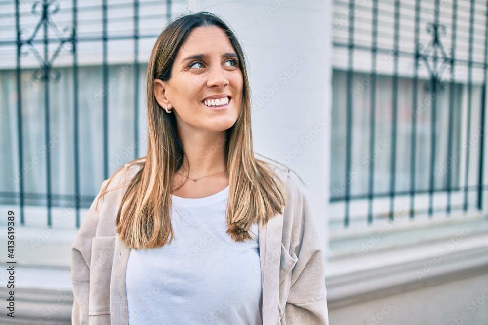 Young caucasian woman smiling happy walking at the city. Young caucasian woman smiling happy walking at the city.