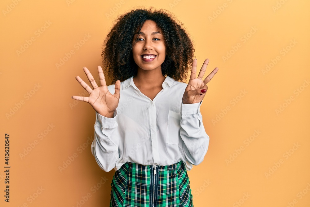 Beautiful african american woman with afro hair wearing scholar skirt showing and pointing up with fingers number eight while smiling confident and happy. Beautiful african american woman with afro hair wearing scholar skirt showing and pointing up with fingers number eight while smiling confident and happy.