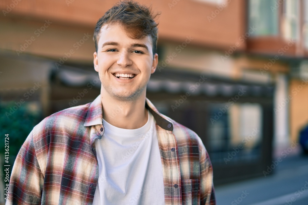 Young caucasian man smiling happy standing at the city. Young caucasian man smiling happy standing at the city.