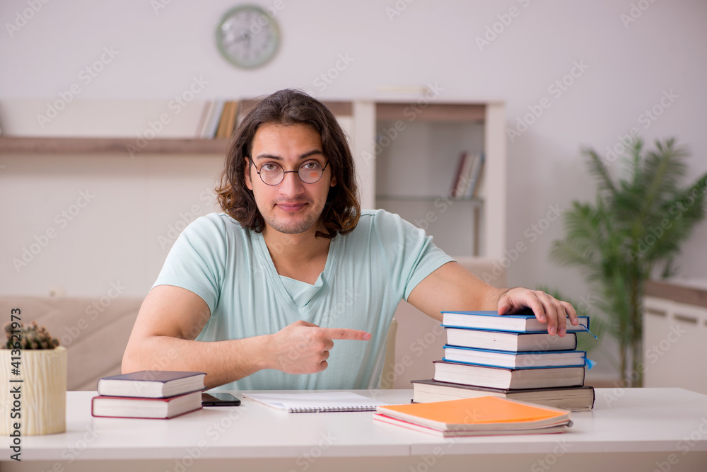 Young male student preparing for exams at home Young male student preparing for exams at home