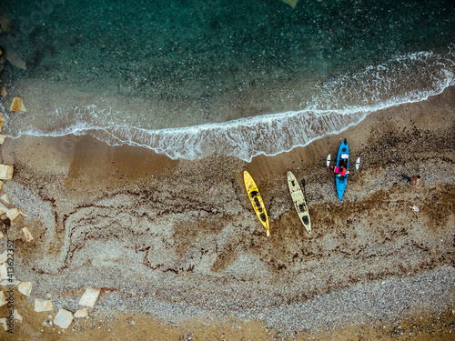 Aerial overhead view of fishing kayks on the coastline of the Mediterranean Sea, Marbella, Malaga, Spain. photo