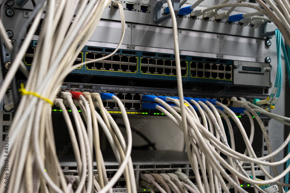 Network cable and switch, data center in server room. Network cable and switch, data center in server room.