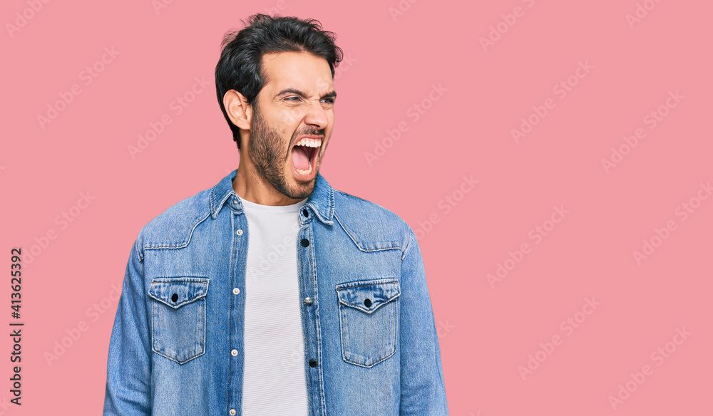 Young hispanic man wearing casual clothes angry and mad screaming frustrated and furious, shouting with anger. rage and aggressive concept. Young hispanic man wearing casual clothes angry and mad screaming frustrated and furious, shouting with anger. rage and aggressive concept.