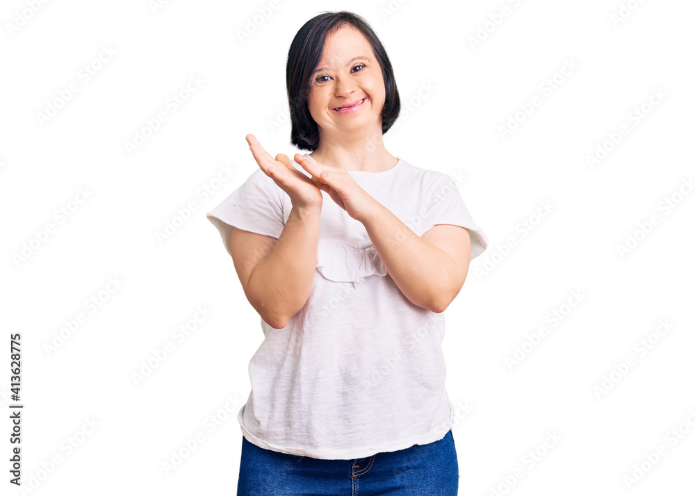 Brunette woman with down syndrome wearing casual white tshirt clapping and applauding happy and joyful, smiling proud hands together Brunette woman with down syndrome wearing casual white tshirt clapping and applauding happy and joyful, smiling proud hands together
