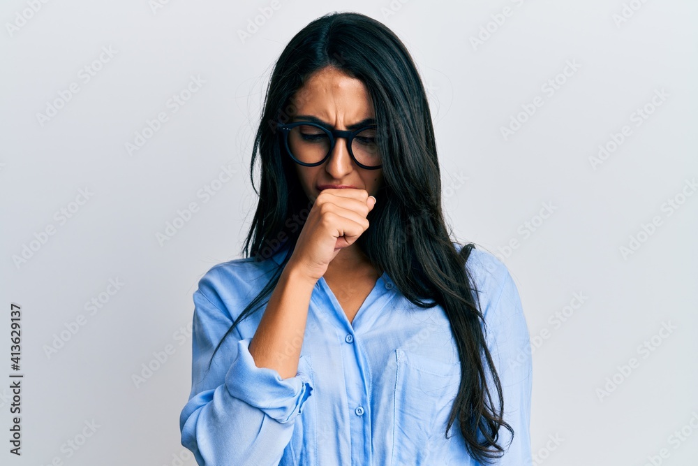 Beautiful hispanic woman wearing business clothes and glasses feeling unwell and coughing as symptom for cold or bronchitis. health care concept.