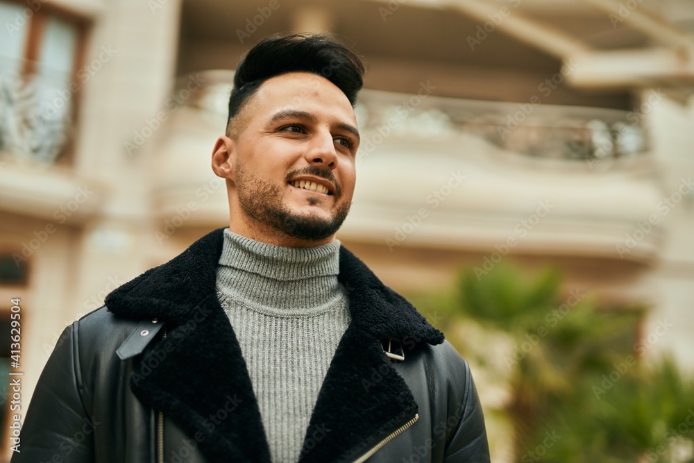 Young arab man smiling happy standing at the city.