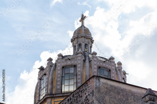 Dome from old Mexican Church under cloudy sky