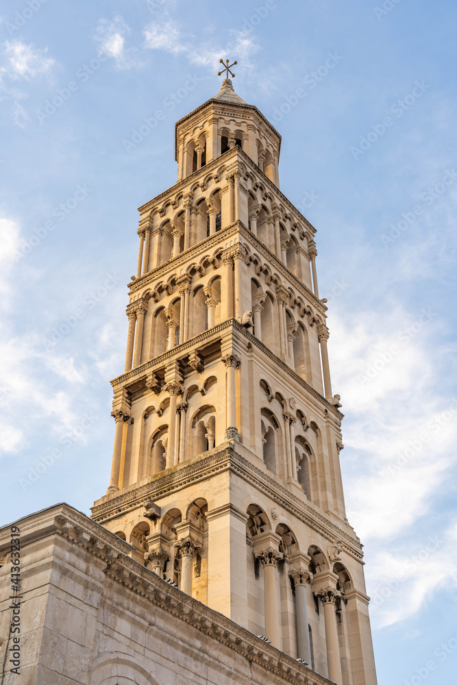 Bell tower of St. Domnius Church in golden sun light in early morning in Diocletian Palace in Split Croatia