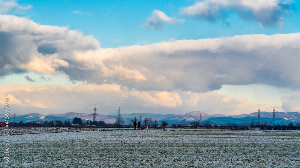 Bizarre big clouds in blue sky over winter landscape Bizarre big clouds in blue sky over winter landscape