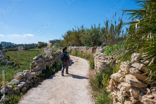 Woman with backpack hiking in Malta