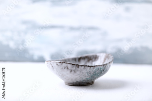Traditional ceramic bowl on bright background. Copy space. 