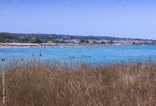 Salento coast: Lido Marini beach, almost sandy and embellished with low cliffs, easy to reach, stretches for more than two kilometres, in the area of the municipalities of Salve and Ugento in Puglia. photo