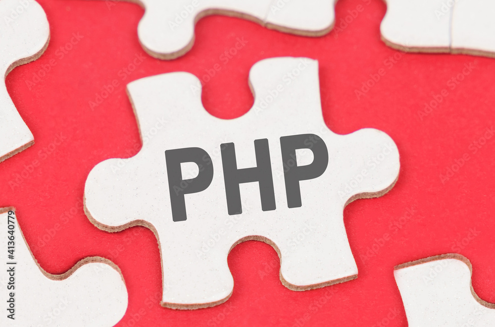 On a red background, among white puzzles lies a puzzle with the inscription - PHP On a red background, among white puzzles lies a puzzle with the inscription - PHP